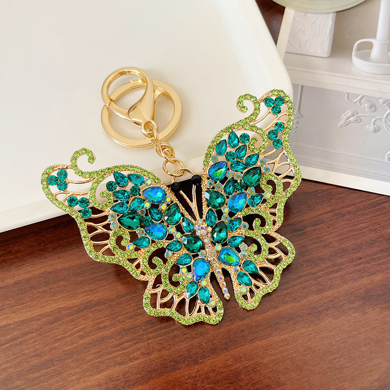 Llavero de mariposa hueco de diamante lleno de cristal de aleación de zinc al por mayor